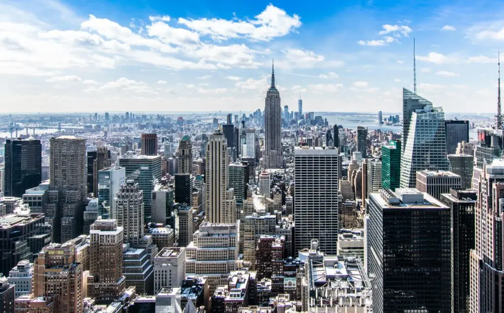 pexels photo 466685 466685 A stunning aerial view of New York City's skyline featuring the iconic Empire State Building under a bright blue sky.